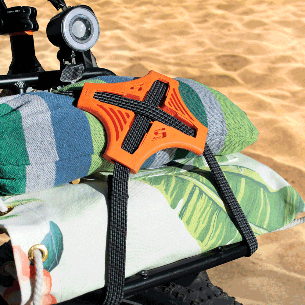 Tack Strap holding towels on bike at the beach