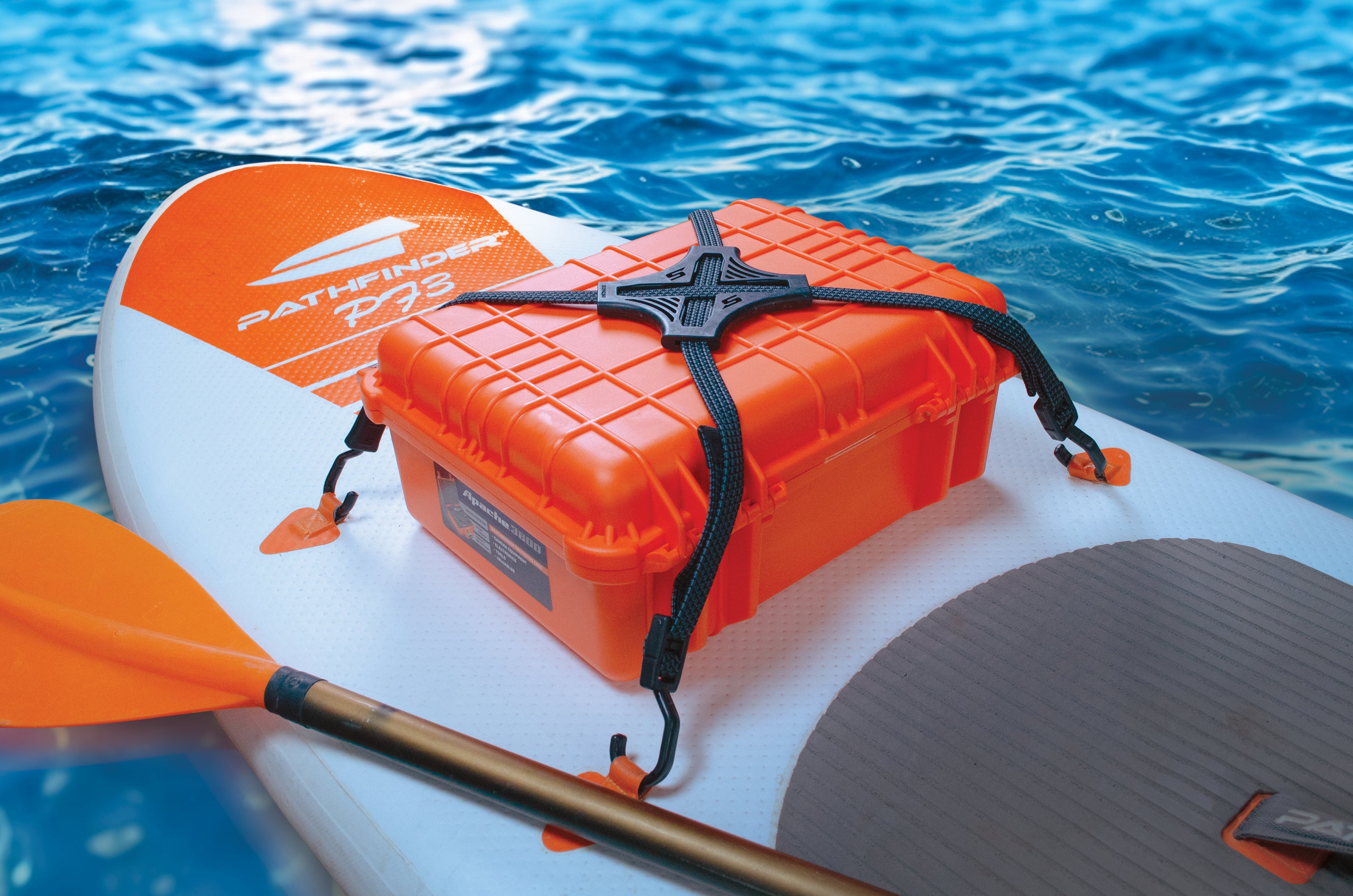 Black Tack Strap securing orange waterproof case on paddleboard NZ